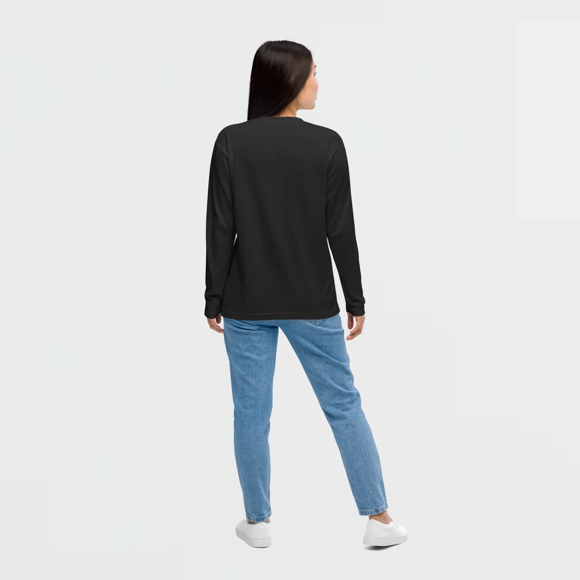 Lady wearing a Super Genki black long-sleeve t-shirt and blue jeans